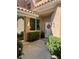 Cozy entrance showcasing a decorated front door, plants, and exterior lighting at 4963 Crooked Stick Way, Las Vegas, NV 89113