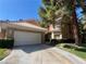 Charming home with a two-car garage and well-maintained front yard and tiled roof at 4963 Crooked Stick Way, Las Vegas, NV 89113
