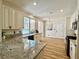 Kitchen featuring granite countertops, modern appliances, and neutral cabinets at 4963 Crooked Stick Way, Las Vegas, NV 89113