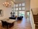 Open-concept living room with a fireplace, high ceilings, and hardwood floors at 4963 Crooked Stick Way, Las Vegas, NV 89113