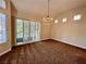 Spacious room with a chandelier, large windows, and modern blinds at 4963 Crooked Stick Way, Las Vegas, NV 89113