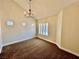 Living room features a vaulted ceiling, neutral walls, and a chandelier at 4963 Crooked Stick Way, Las Vegas, NV 89113