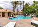 Community pool with plenty of lounge chairs and palm trees at 4963 Crooked Stick Way, Las Vegas, NV 89113