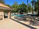 Inviting pool area with lounge chairs for relaxation and a covered patio at 4963 Crooked Stick Way, Las Vegas, NV 89113