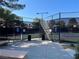 Community tennis courts featuring benches, recycling bins, and covered net at 4963 Crooked Stick Way, Las Vegas, NV 89113