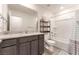 Bright bathroom with granite countertops, a modern vanity and a shower-tub combination at 518 Descubir Ave, North Las Vegas, NV 89081