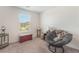 Inviting bedroom featuring a cozy chair, and ample natural light from the large window at 518 Descubir Ave, North Las Vegas, NV 89081