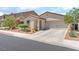 Attractive home with desert landscaping and a two-car garage, presenting a neat and inviting facade at 518 Descubir Ave, North Las Vegas, NV 89081