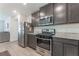 Updated kitchen features stainless steel appliances, granite countertops, and plenty of storage space at 518 Descubir Ave, North Las Vegas, NV 89081