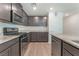 Modern kitchen with gray cabinets, stainless steel appliances, and granite countertops at 518 Descubir Ave, North Las Vegas, NV 89081