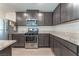 Well-equipped kitchen with gray cabinets, stainless steel appliances, and granite countertops at 518 Descubir Ave, North Las Vegas, NV 89081