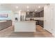 Modern kitchen featuring gray cabinets, stainless steel appliances, and a spacious island with countertop seating at 518 Descubir Ave, North Las Vegas, NV 89081