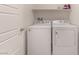 Clean and bright laundry area with washer and dryer hookups and a white door at 518 Descubir Ave, North Las Vegas, NV 89081