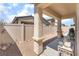 Covered patio with stone columns and a gravel yard, offering a tranquil outdoor space at 518 Descubir Ave, North Las Vegas, NV 89081