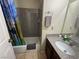 Cozy bathroom featuring a shower-tub combination, granite countertop, and neutral-toned tile flooring at 5499 Indian River Dr # 356, Las Vegas, NV 89103