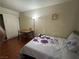 Inviting bedroom features a full bed, desk, wood floors, and closet with sliding doors at 5499 Indian River Dr # 356, Las Vegas, NV 89103
