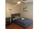 Bedroom featuring wood-look flooring, a ceiling fan, and a cozy bed, creating a comfortable space at 5499 Indian River Dr # 356, Las Vegas, NV 89103