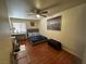 Bedroom with wood floors, neutral-toned walls, a ceiling fan, and ample natural light from a window at 5499 Indian River Dr # 356, Las Vegas, NV 89103