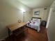 Comfortable bedroom with hardwood floors, a full-sized bed, a desk and stool, and ample lighting at 5499 Indian River Dr # 356, Las Vegas, NV 89103