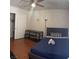 Bedroom features a bed, desk, and closet space, complemented by neutral walls and wood-look flooring at 5499 Indian River Dr # 356, Las Vegas, NV 89103