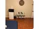 Bedroom with wood floors including a mini fridge, microwave, tea kettle, and wall decor at 5499 Indian River Dr # 356, Las Vegas, NV 89103