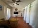 Comfortable living room with ceiling fan, large windows, and a television on a white stand at 5499 Indian River Dr # 356, Las Vegas, NV 89103