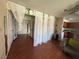 Cozy living room featuring hardwood floors, french doors, and unique sheer curtain accents at 5499 Indian River Dr # 356, Las Vegas, NV 89103
