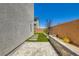Modern backyard features a brick wall, stone pathway, landscaped area, and textured wall, offering a private outdoor retreat at 5804 Gossamer Stone Ct, Las Vegas, NV 89141