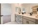 Modern bathroom with double sink vanity, large mirrors, and view into bedroom at 5804 Gossamer Stone Ct, Las Vegas, NV 89141