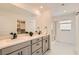 Bathroom with double sinks, large mirror, modern vanity, and glass-enclosed shower at 5804 Gossamer Stone Ct, Las Vegas, NV 89141