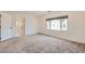Spacious bedroom with neutral carpet and large window with blinds for natural light at 5804 Gossamer Stone Ct, Las Vegas, NV 89141
