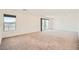 Spacious bedroom featuring neutral colored carpet and a sliding glass door at 5804 Gossamer Stone Ct, Las Vegas, NV 89141