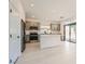 Modern kitchen featuring stainless steel appliances, gray cabinets, island, and sliding doors to outdoor area at 5804 Gossamer Stone Ct, Las Vegas, NV 89141