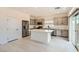 Modern kitchen with stainless steel appliances, an island, gray cabinets, and tiled floors at 5804 Gossamer Stone Ct, Las Vegas, NV 89141