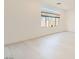 Bright, open living room featuring sleek, tiled floors and neutral walls at 5804 Gossamer Stone Ct, Las Vegas, NV 89141
