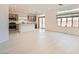 Bright, open-concept living space featuring sleek, tiled floors and abundant natural light from large windows at 5804 Gossamer Stone Ct, Las Vegas, NV 89141