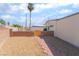 Low-maintenance backyard with gravel and paver pathway, offering easy upkeep at 600 Berry Cir, Las Vegas, NV 89107