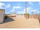 Low maintenance backyard with desert landscaping, block and wood fences, and gravel ground cover at 600 Berry Cir, Las Vegas, NV 89107
