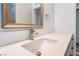 Bright bathroom features a modern vanity with a stone countertop and a modern faucet at 600 Berry Cir, Las Vegas, NV 89107