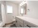 Bright bathroom features a modern vanity with a stone countertop and a shower with a white curtain at 600 Berry Cir, Las Vegas, NV 89107