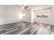 Large bedroom with wood-look flooring, dual windows, and a ceiling fan ensuring a comfortable space at 600 Berry Cir, Las Vegas, NV 89107
