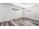 Well-lit bedroom features neutral walls, two windows bringing natural light, and contemporary-style flooring at 600 Berry Cir, Las Vegas, NV 89107
