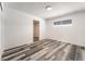 A bright bedroom featuring wood floors, white walls, and a window at 600 Berry Cir, Las Vegas, NV 89107