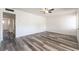 Spacious bedroom with stylish wood-look flooring, ceiling fan, and freshly painted walls and trim at 600 Berry Cir, Las Vegas, NV 89107