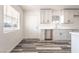 Bright kitchen with quartz countertops, white cabinets, modern hardware, and durable flooring at 600 Berry Cir, Las Vegas, NV 89107