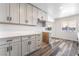 Stylish kitchen with white cabinets, quartz countertops, stainless steel appliances, and wood-look flooring at 600 Berry Cir, Las Vegas, NV 89107