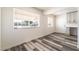 Bright living space featuring modern flooring, two windows, and a built-in desk at 600 Berry Cir, Las Vegas, NV 89107