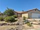 Charming single-story home featuring a rockscaped front yard, mature landscaping, and a two car garage at 6357 Cobalt Ln, Las Vegas, NV 89146