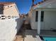 View of backyard with block wall, pool equipment, and pathway to the pool at 6636 Old Oxford Ave, Las Vegas, NV 89108