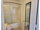 Cozy bathroom showcasing a shower with sliding doors, a black framed mirror, and tiled flooring at 6636 Old Oxford Ave, Las Vegas, NV 89108